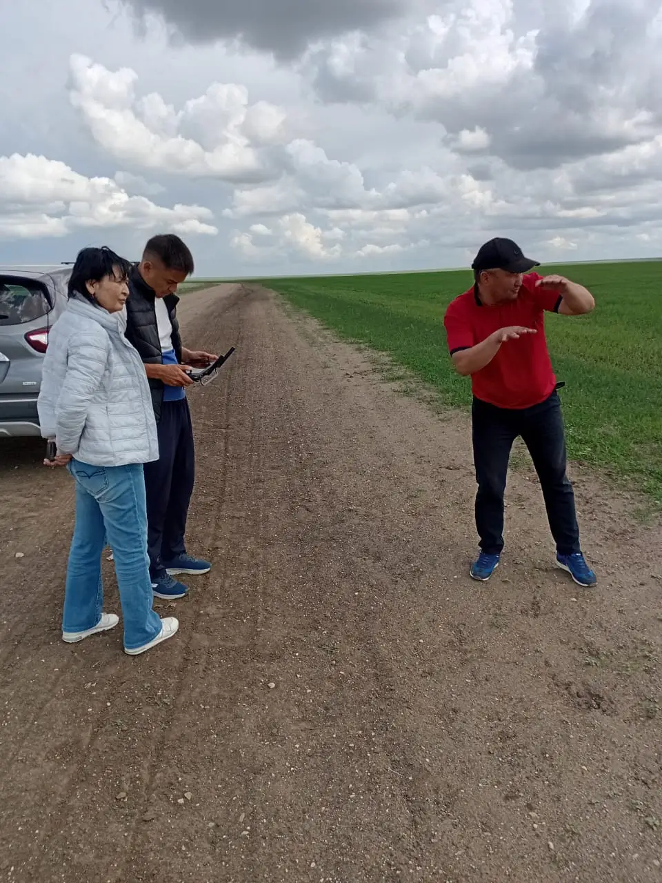 Rodina field visit participants inspecting forage crops